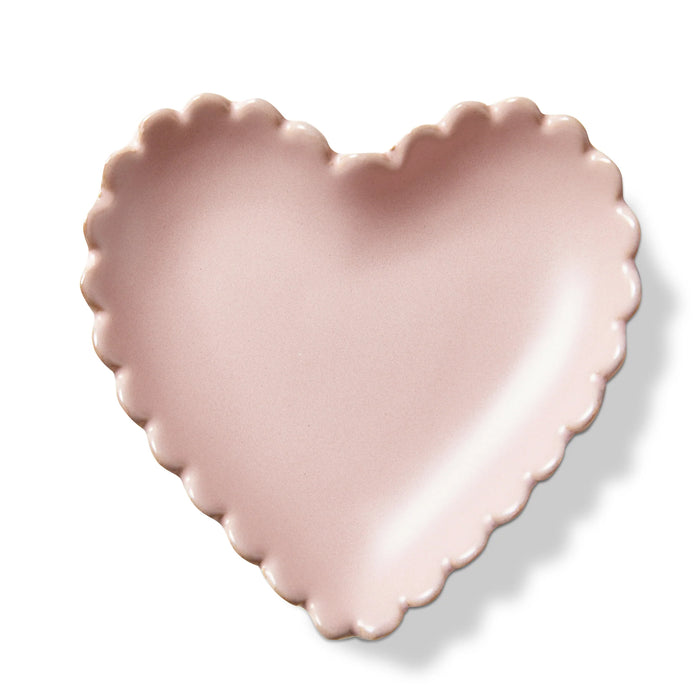 Pink heart-shaped ceramic plate on a white background