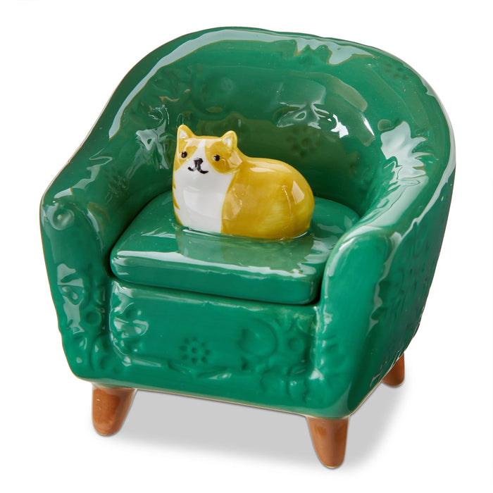 Green ceramic chair with a small dog figurine on a white background