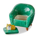 Green ceramic armchair with a small dog figurine on a white background