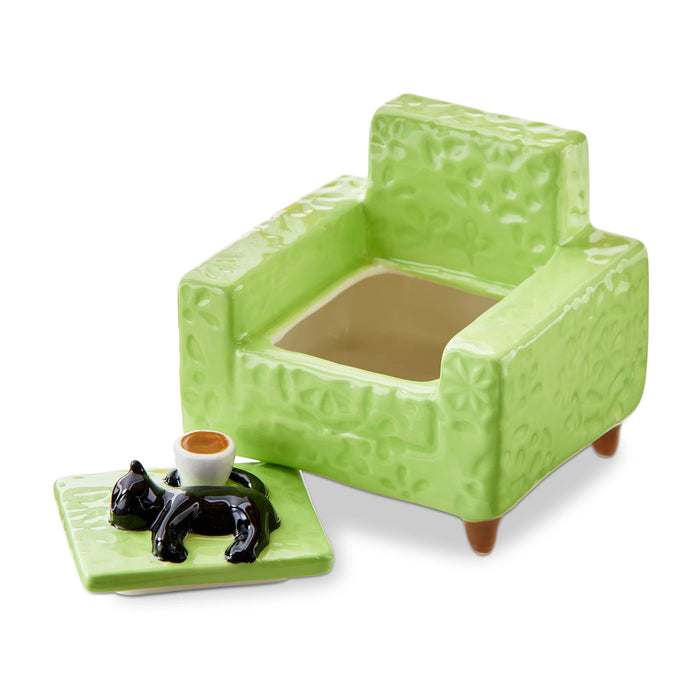 Green ceramic armchair with a small table and figurines on a white background