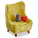 Yellow chair with a cat figurine and red cushion on a white background