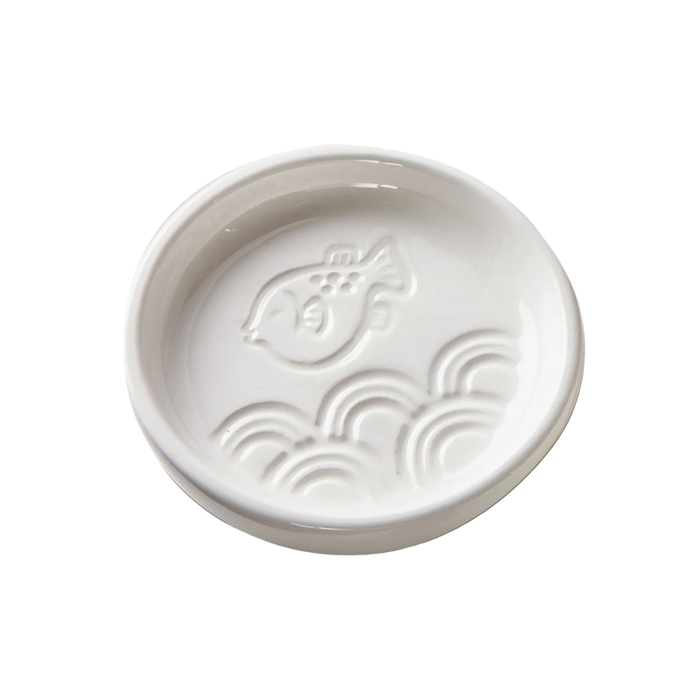 White ceramic bowl with fish design on a white background