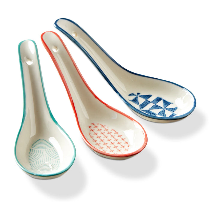 Three ceramic spoons with different patterns on a white background