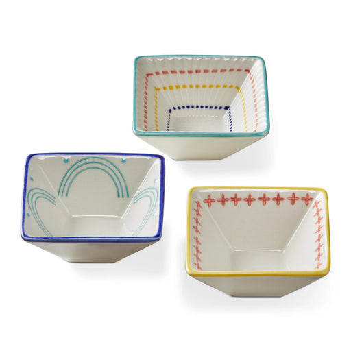 Three small ceramic bowls with colorful decorative edges on a white background