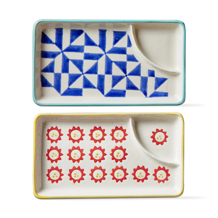 Two ceramic trays with geometric patterns on a white background