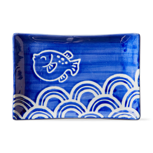 Blue ceramic tray with white fish and wave patterns on a white background