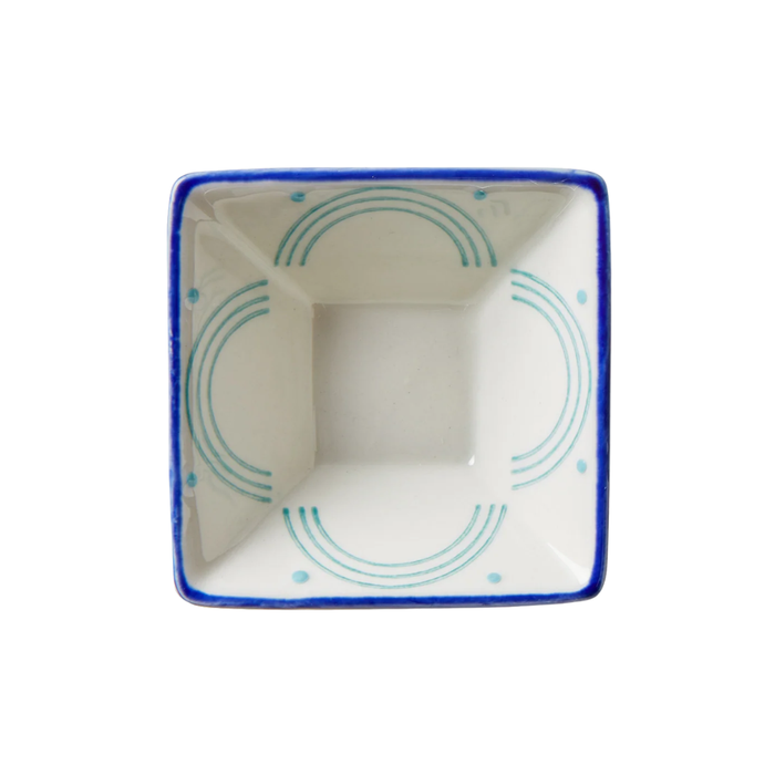 Square ceramic dish with blue rim and green interior design on a white background