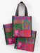 Colorful patterned bags with black handles on a white background