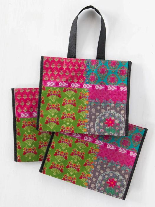 Set of three patterned bags on a white background