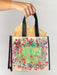 Floral and butterfly design bag with 'Happy Bag' text held by a hand against a plain background