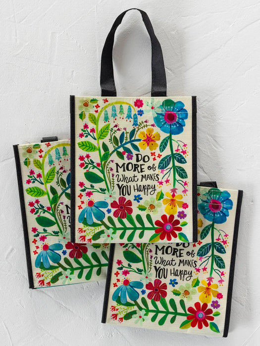 Set of three colorful tote bags with floral designs and motivational text on a white background