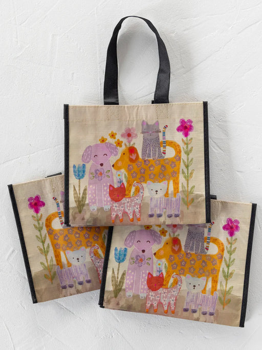 Set of three colorful tote bags with animal designs on a white background