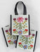 Set of three floral tote bags with black handles on a light gray background