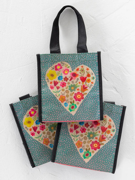 Tote bag with floral heart design on a white background