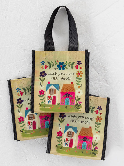 Set of three decorative bags with house illustrations and text on a white background