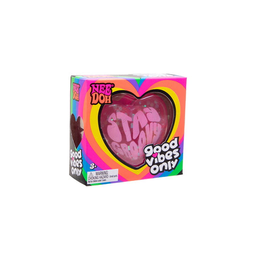 Heart-shaped pink object with 'Good Vibes Only' text in a colorful box packaging on a white background
