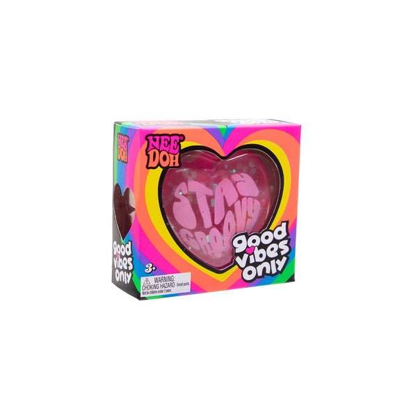 Heart-shaped pink object with 'Good Vibes Only' text in a colorful box packaging on a white background