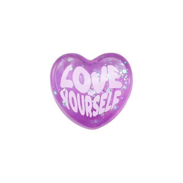 Purple heart-shaped object with 'LOVE YOURSELF' text on a white background