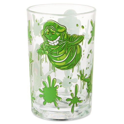 A clear glass drinking tumbler featuring a green Ghostbusters Slimer character graphic and green splatter details, shown on a plain white background.