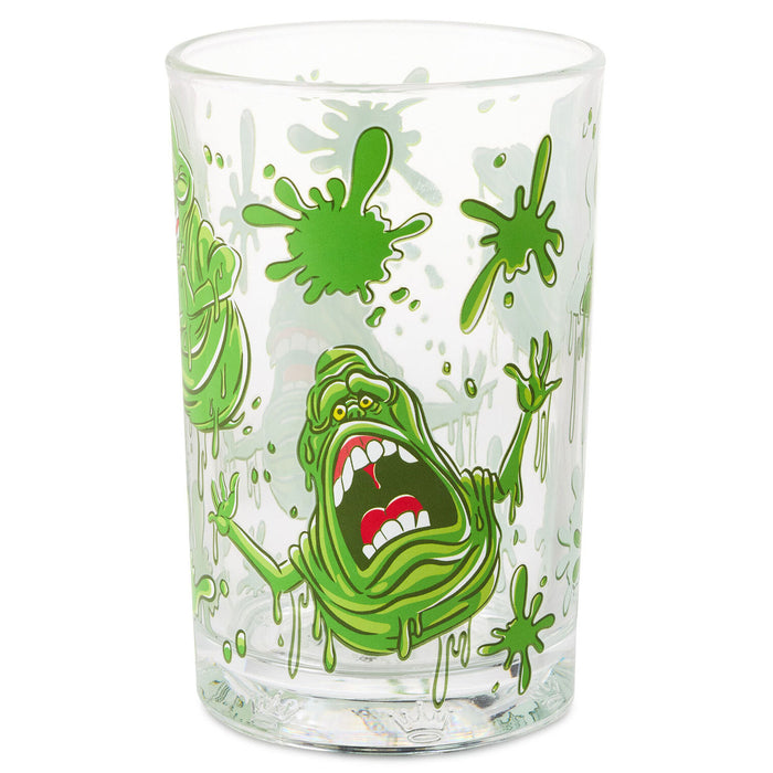 A clear glass drinking tumbler featuring a green slime monster graphic inspired by Ghostbusters, with green splatters and drips on a white background.