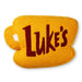 Yellow mug-shaped pillow with 'Luke's' text on a white background