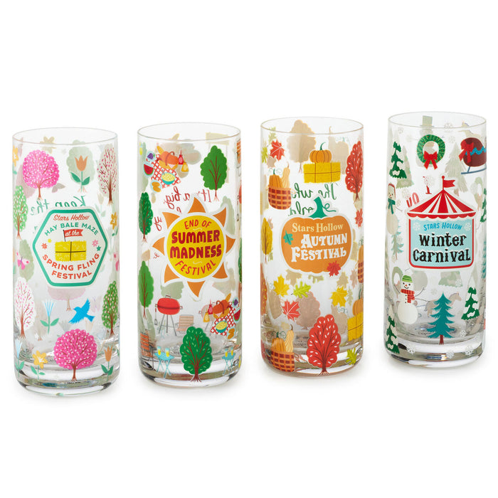 Four glass tumblers with festive designs for different seasons on a white background.