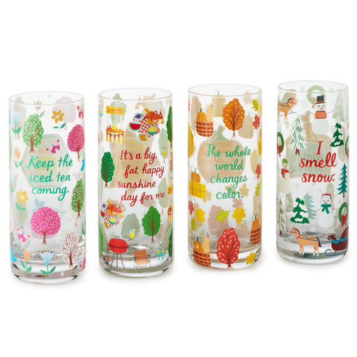 Four glass tumblers with festive designs for different seasons on a white background.