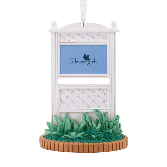 Decorative ornament resembling a white lattice structure with 'Gilmore Girls' branding on a white background.