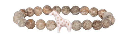 Bracelet with stone beads and a small dog figurine on a white background