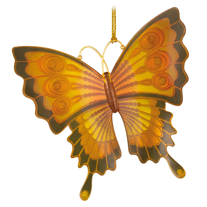 Butterfly-shaped ornament with orange and brown colors on a white background