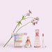 Good Chemistry Sugar Berry perfume set with flowers on a light pink background
