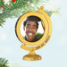 Gold graduation-themed ornament with a photo of a person and 'Look Out, World! 2026' text, hanging on a Christmas tree.