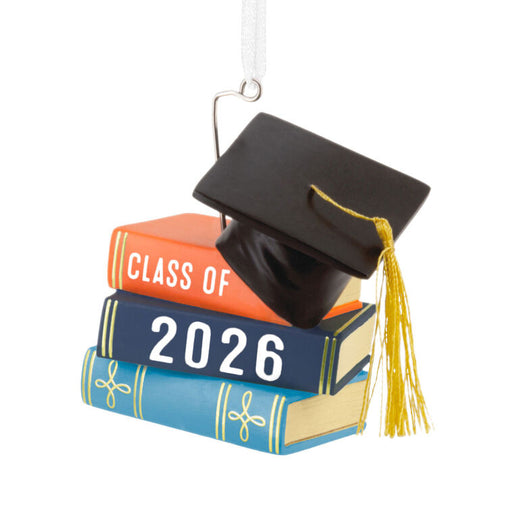 Graduation-themed ornament with 'Class of 2026' books and cap on a white background