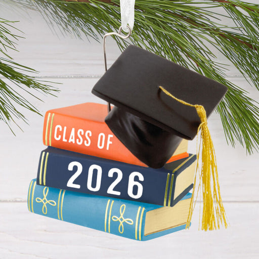 Graduation-themed ornament with books and cap, featuring 'Class of 2026'.