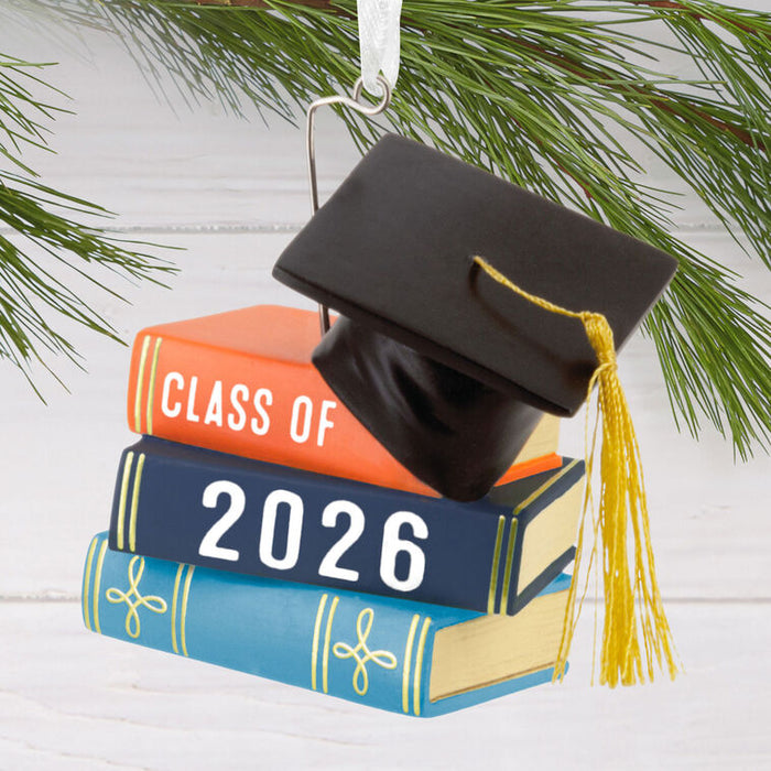 Graduation-themed ornament with books and cap, featuring 'Class of 2026'.
