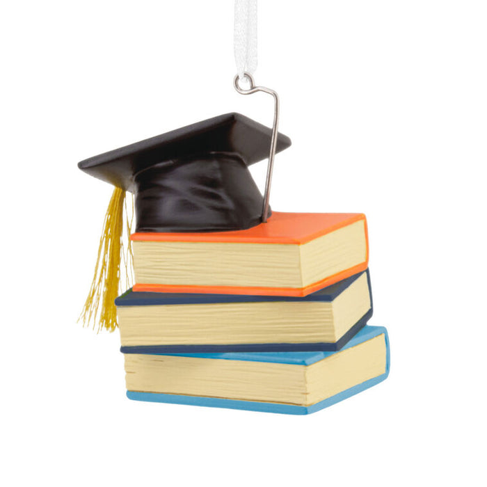 Graduation cap and books ornament on a white background