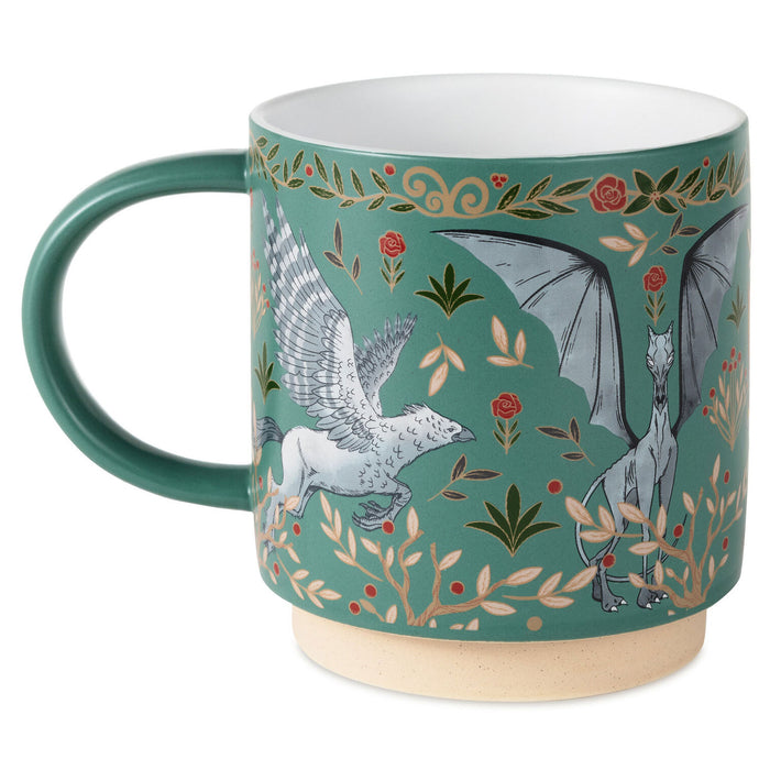A ceramic mug with a teal green body, featuring a detailed illustration of a white griffin and a gray dragon amidst gold foliage and red roses on a teal background. The mug has a solid teal green handle, a white interior, and a natural beige clay foot.