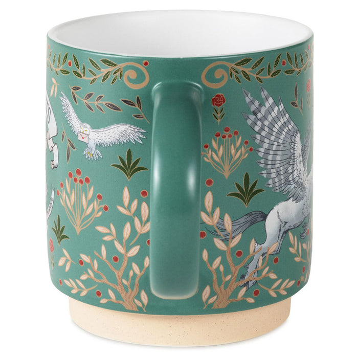 A ceramic mug with a teal green background decorated with a pattern of white horses, gold vines, and small red berries, featuring a beige speckled base.