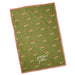 An olive green tea towel with a repeating autumn leaf pattern and a red gingham border, featuring the white script text 'grateful to gather' near the bottom.