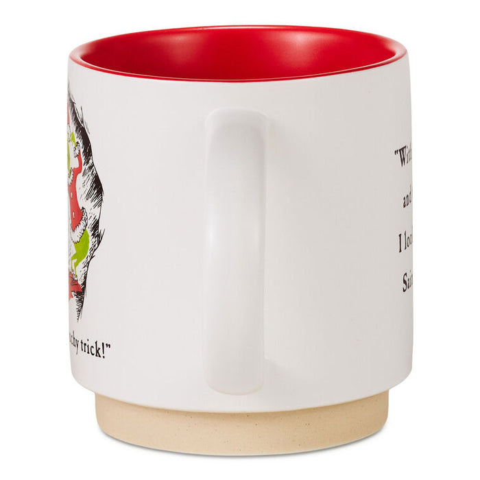 A white ceramic mug with a red interior and a natural beige clay foot ring, featuring a partial illustration of a cat and black text on the side.