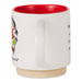 A white ceramic mug with a red interior and a natural beige clay foot ring, featuring a partial illustration of a cat and black text on the side.