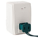 White wall outlet with a green plug on a white background