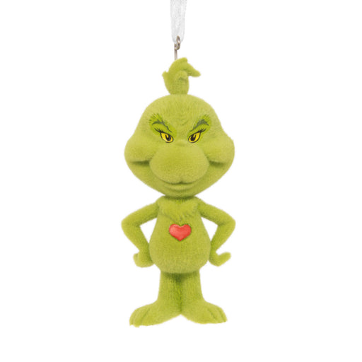 A green Grinch plush ornament with yellow eyes, a red heart on the chest, and a white hanging loop at the top, shown against a plain white background.