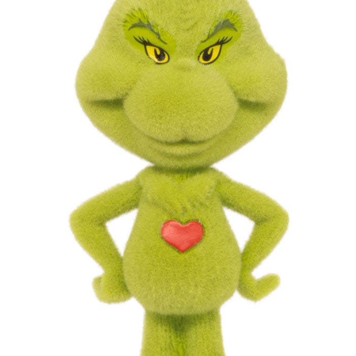 Green plush toy with a red heart on a white background