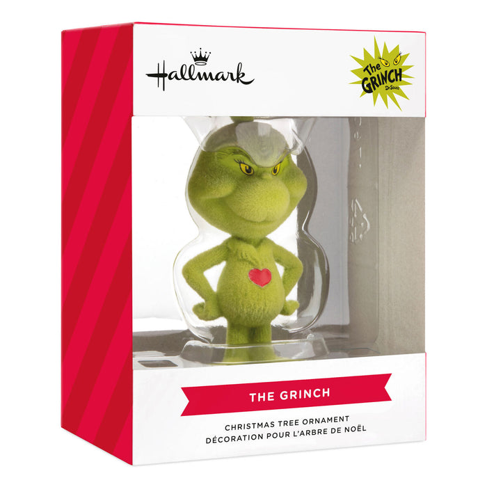 Hallmark The Grinch Christmas Tree Ornament in its original retail packaging, featuring a green plush Grinch figure inside a clear window box with red and white branding.