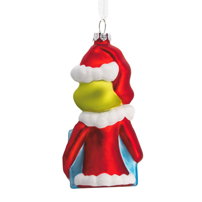 Christmas ornament of a character in a red outfit with white accents on a white background