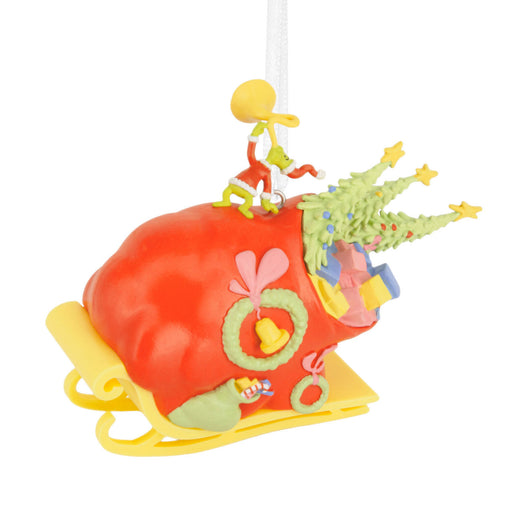 Colorful Christmas ornament with a red base, yellow slide, and small figures on a white background