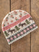 Knitted hat with floral and animal pattern on a wooden background
