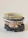 Stack of various bracelets on a light background