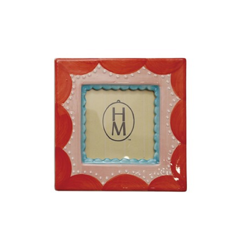 Decorative red picture frame with scalloped edges on a white background